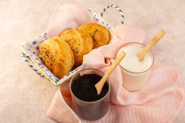 top-view-baked-buns-hot-tasty-fresh-inside-bread-bin-along-with-salt-pepper-pink_140725-24300