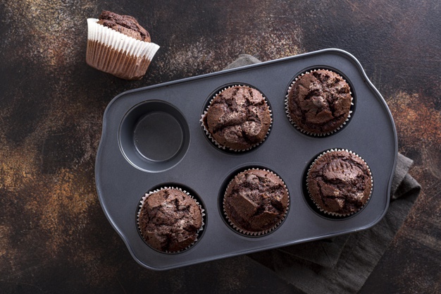 top-view-chocolate-muffins-tray-with-cloth_23-2148569664